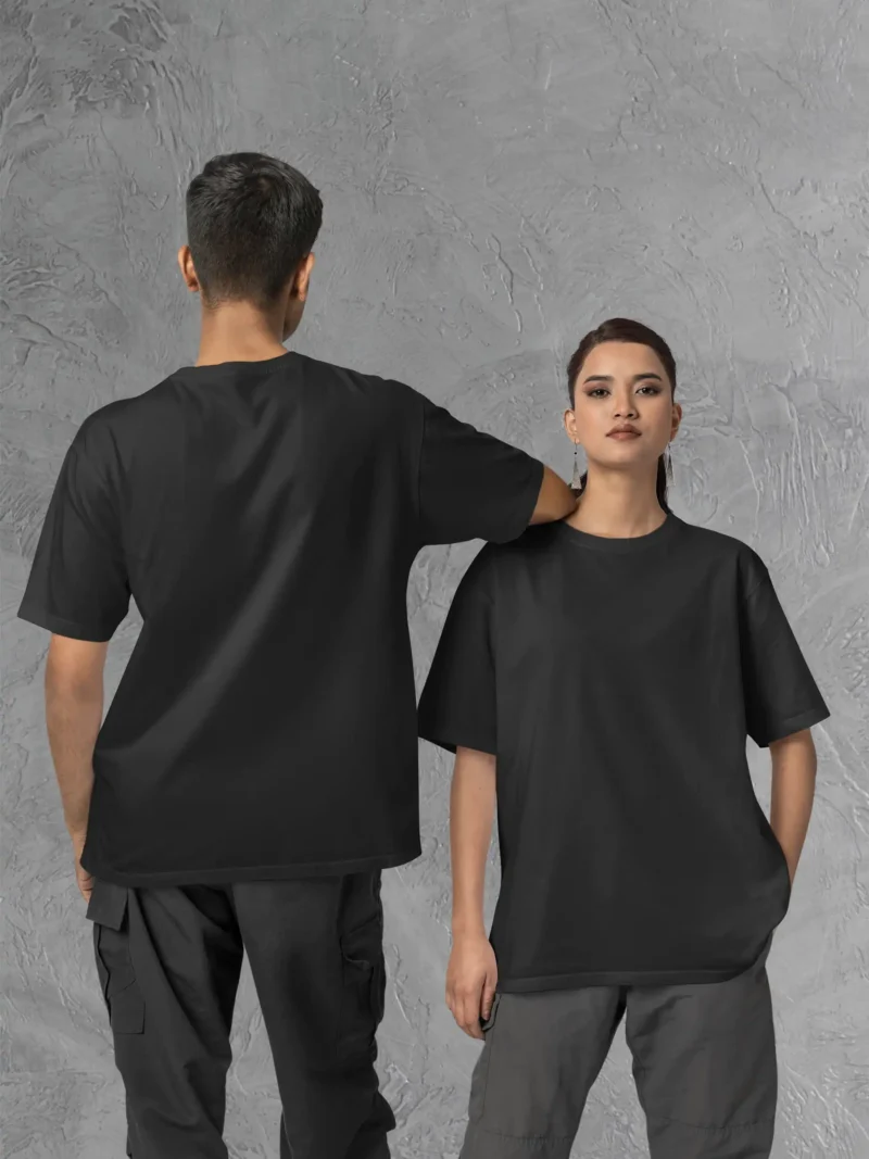 Couple posing in M4S Solids Oversized Black Unisex Tee