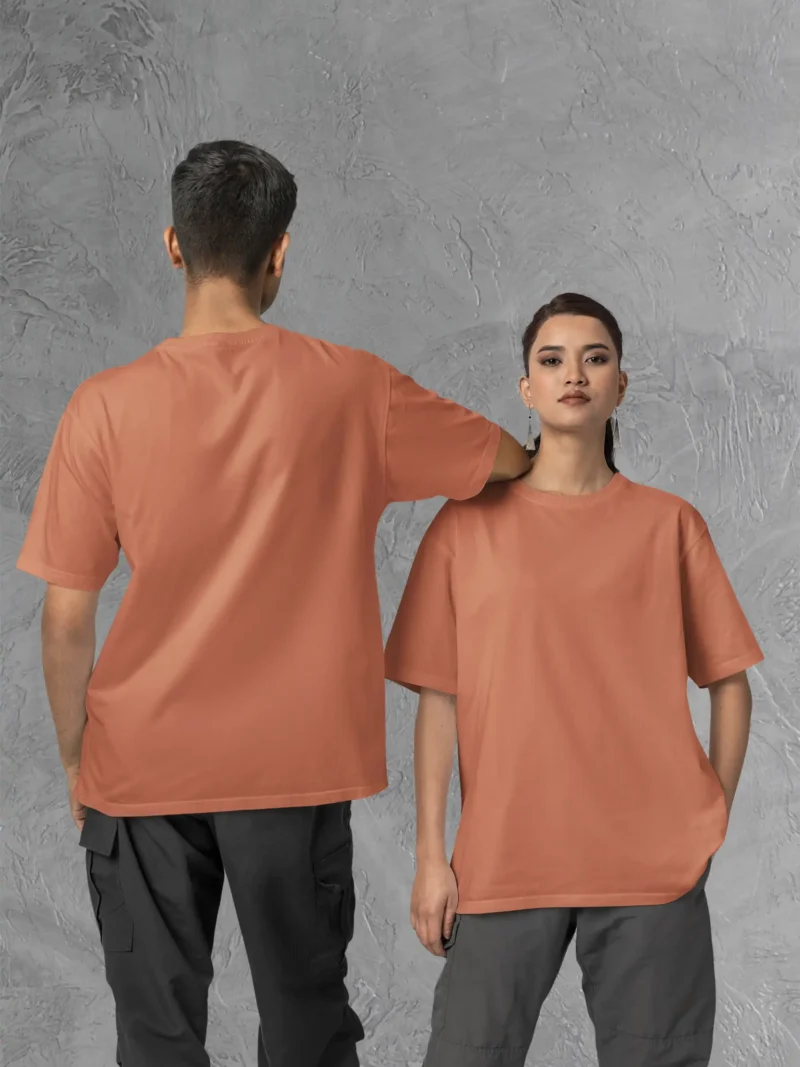 Couple posing in M4S Solids Oversized Coral Unisex Tee