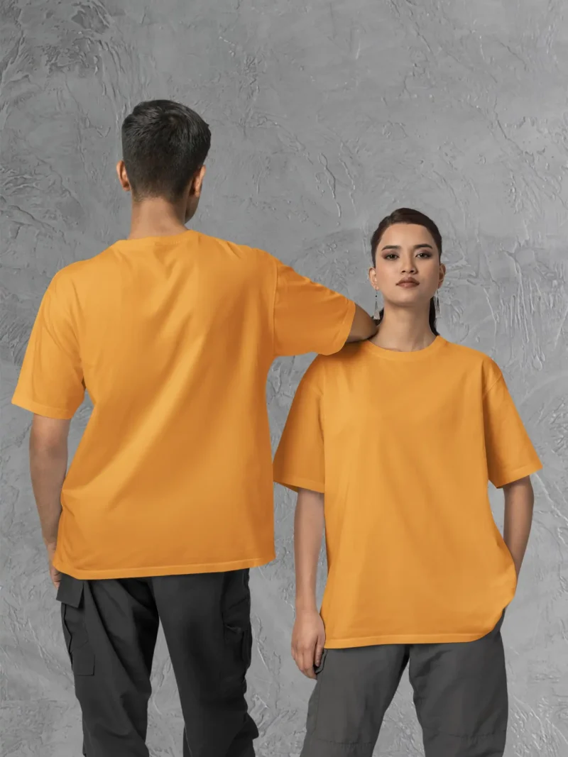 Couple posing in M4S Solids Oversized Golden Yellow Unisex Tee