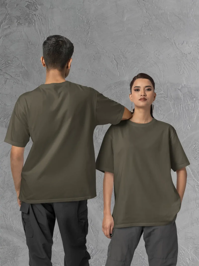 Couple posing in M4S Solids Oversized Olive Unisex Tee