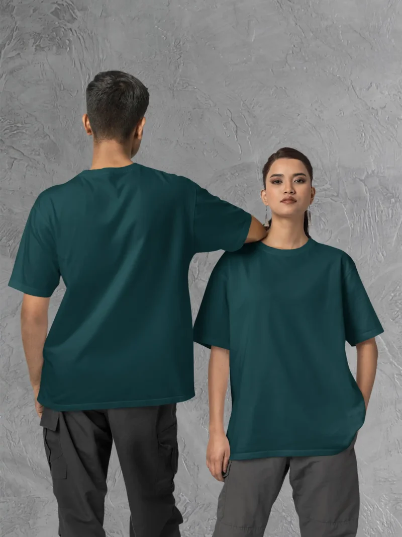 Couple posing in M4S Solids Oversized Petrol Blue Unisex Tee