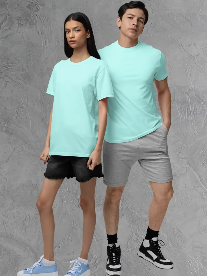 Couple posing in M4S Solids Stretch Mint Unisex Tee