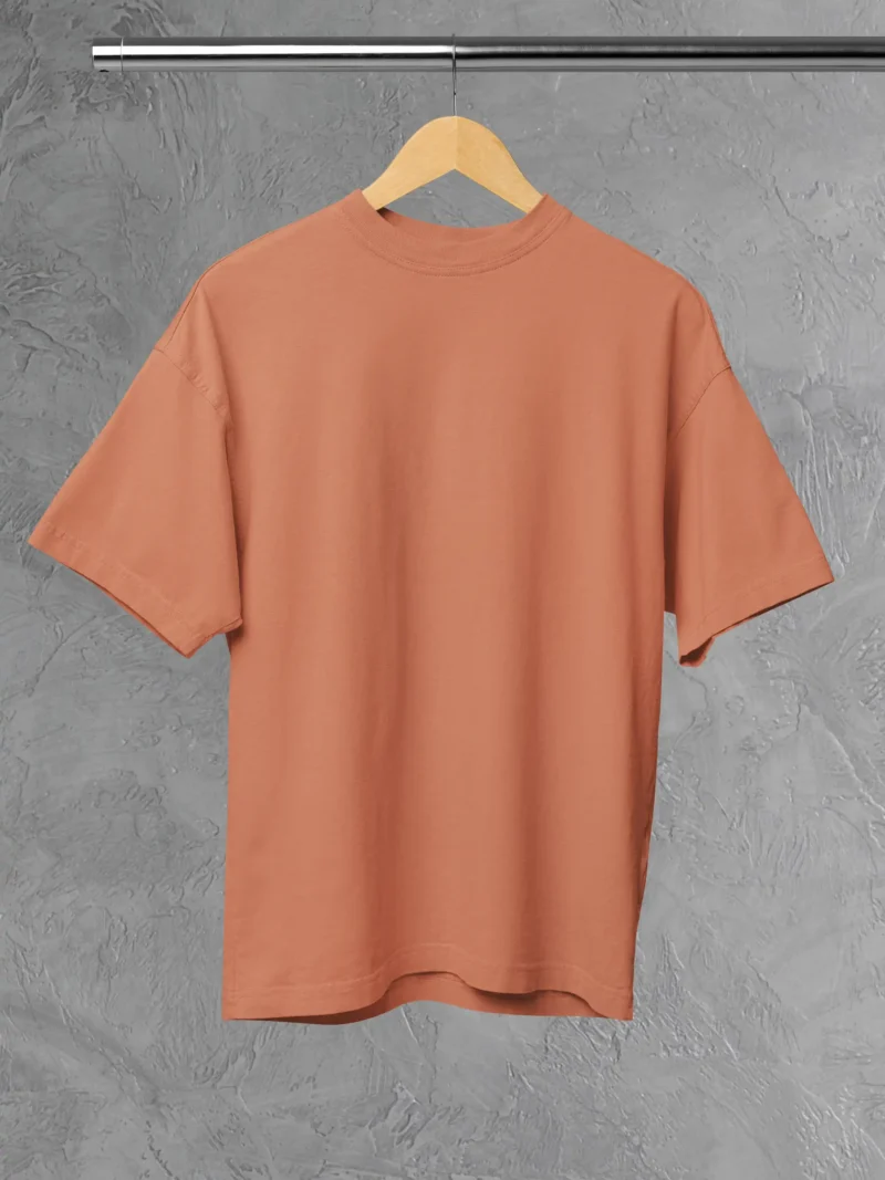 M4S Solids Oversized Coral Unisex Tee Placed on a hanger