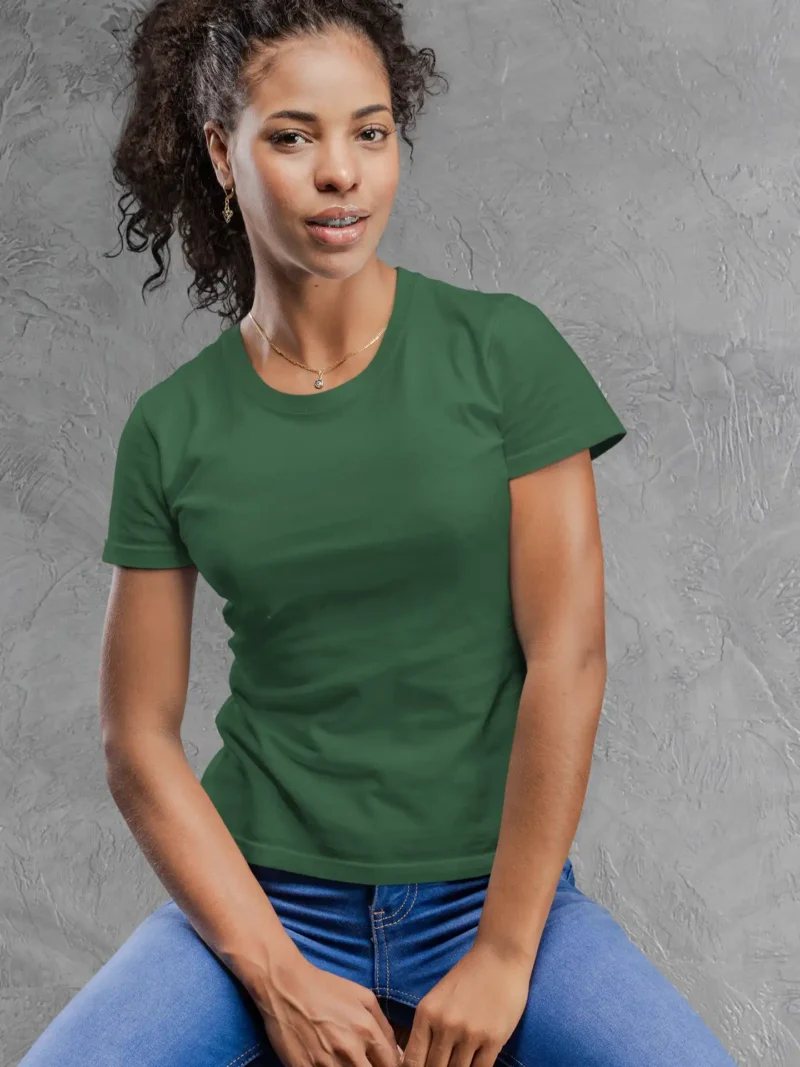 Model wearing M4S Solids Female Classic Bottle Green Tee against a concrete backdrop