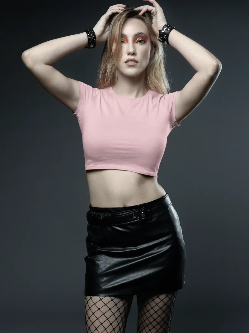 Female model wearing M4S Solids Light Pink Baby Tee in a studio 1