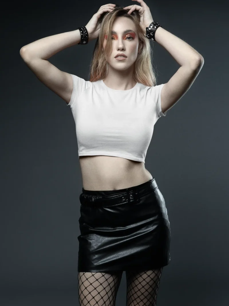 Female model wearing M4S Solids White Baby Tee in a studio 1