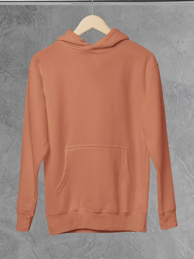 M4S Solids Coral Unisex Pullover Hoodie placed on a hanger