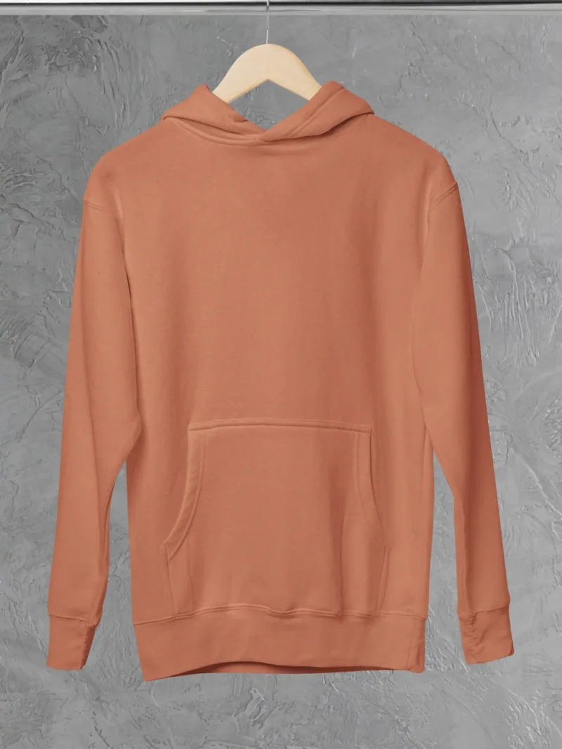 M4S Solids Coral Unisex Pullover Hoodie placed on a hanger