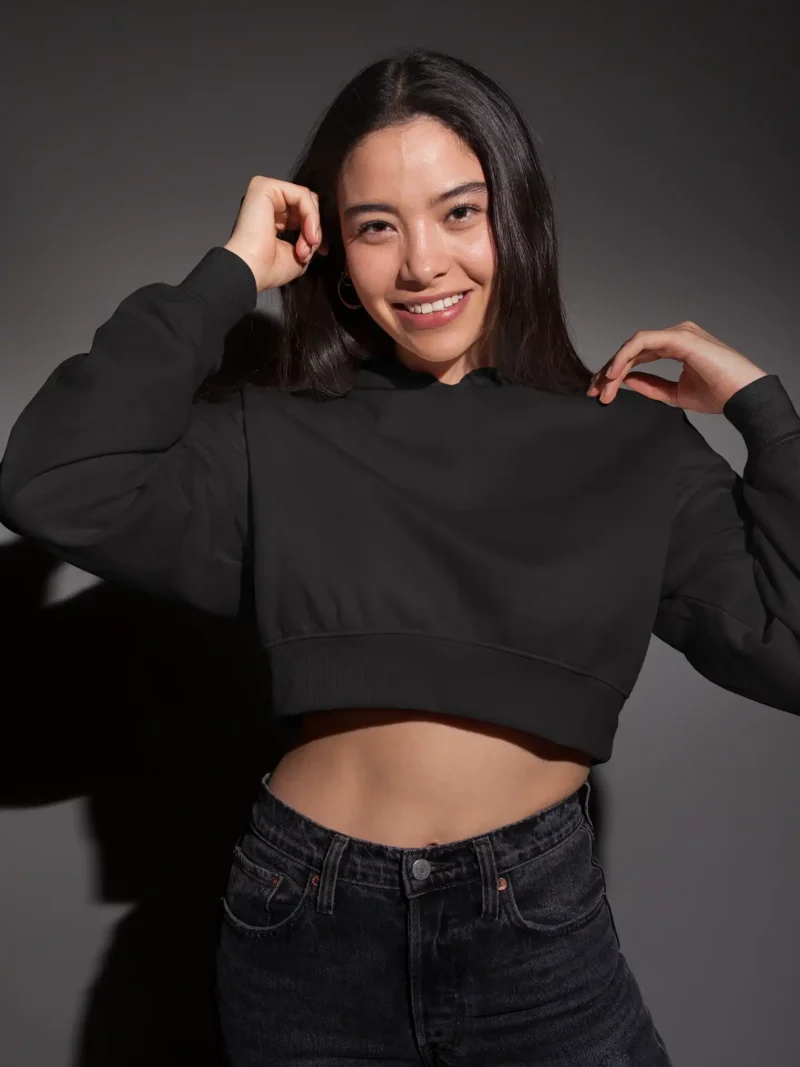 Woman wearing M4S Solids Black Cropped Hoodie in a studio 1