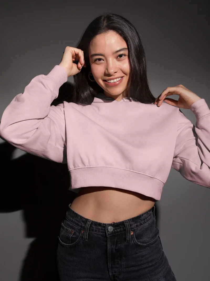 Woman wearing M4S Solids Light Pink Cropped Hoodie in a studio 1