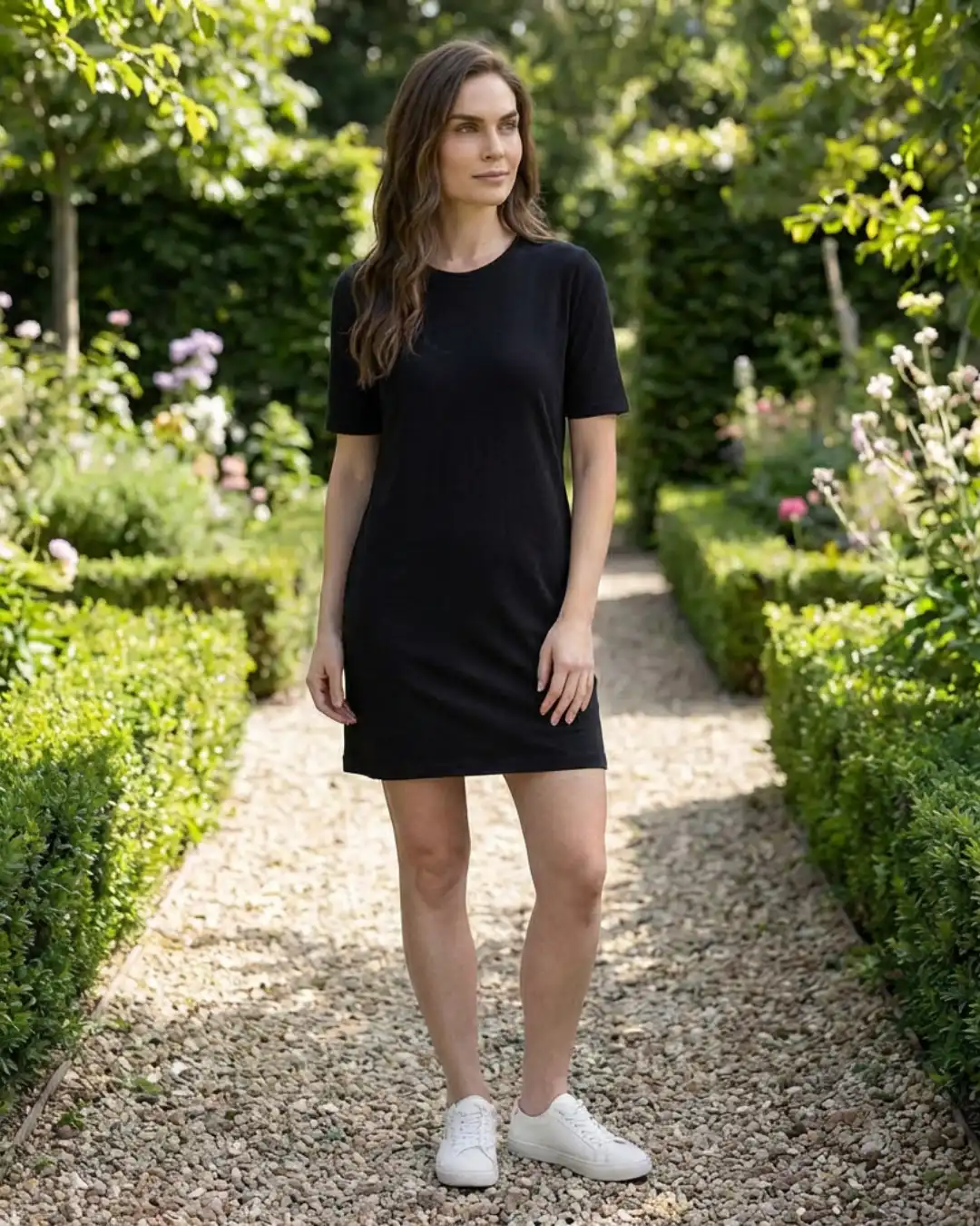 Female model wearing M4S Solids Black T-Shirt Dress Outdoors Female model wearing M4S Solids Black T-Shirt Dress Outdoors