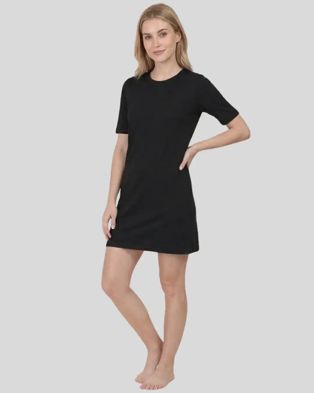 Front shot of Female model wearing M4S Solids Black T-Shirt Dress in a studio Front shot of Female model wearing M4S Solids Black T-Shirt Dress in a studio