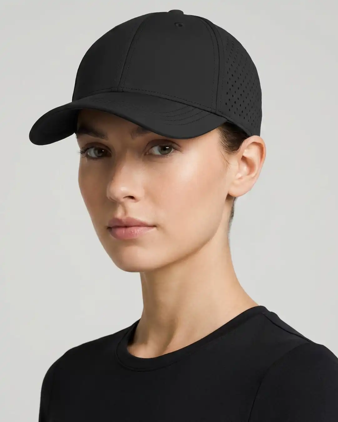 Woman wearing M4S Solids Black Unisex Sports Cap in a studio Woman wearing M4S Solids Black Unisex Sports Cap in a studio