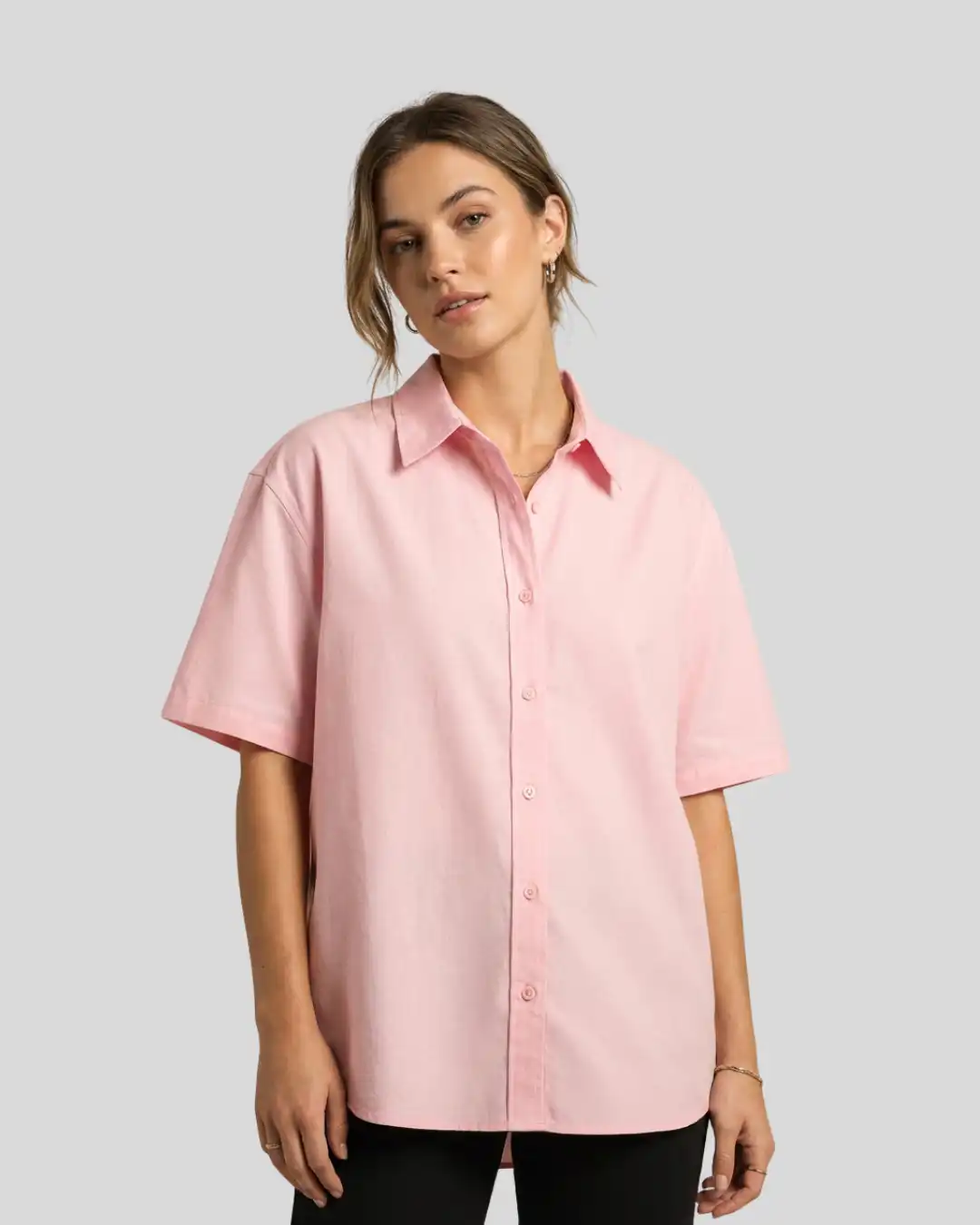 Woman wearing M4S Solids Light Pink Unisex Oversized Shirt in a studio Woman wearing M4S Solids Light Pink Unisex Oversized Shirt in a studio