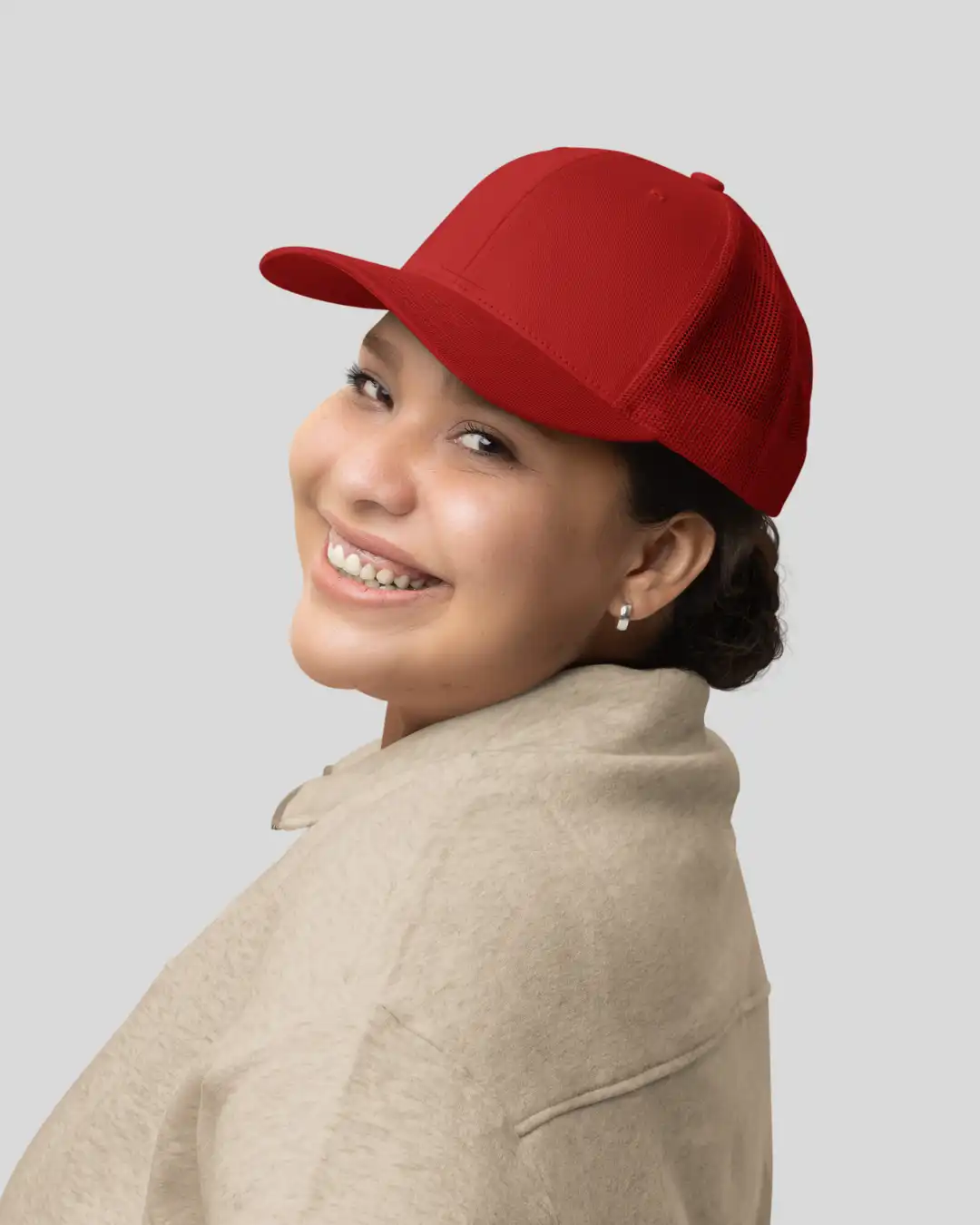 Woman wearing M4S Solids Red Unisex Classic Trucker Cap in a studio Woman wearing M4S Solids Red Unisex Classic Trucker Cap in a studio
