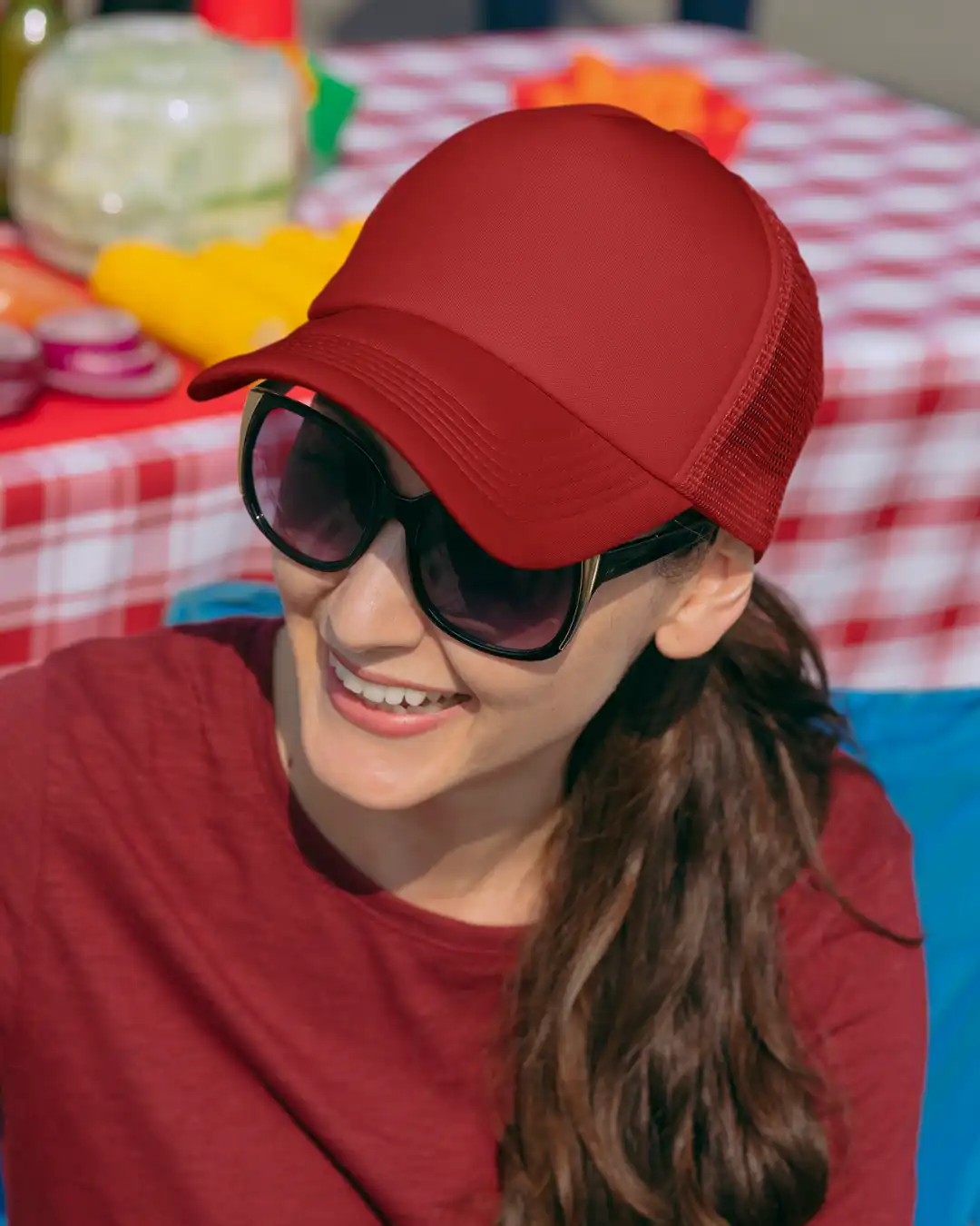 Woman wearing M4S Solids Red Unisex Classic Trucker Cap outdoors Woman wearing M4S Solids Red Unisex Classic Trucker Cap outdoors