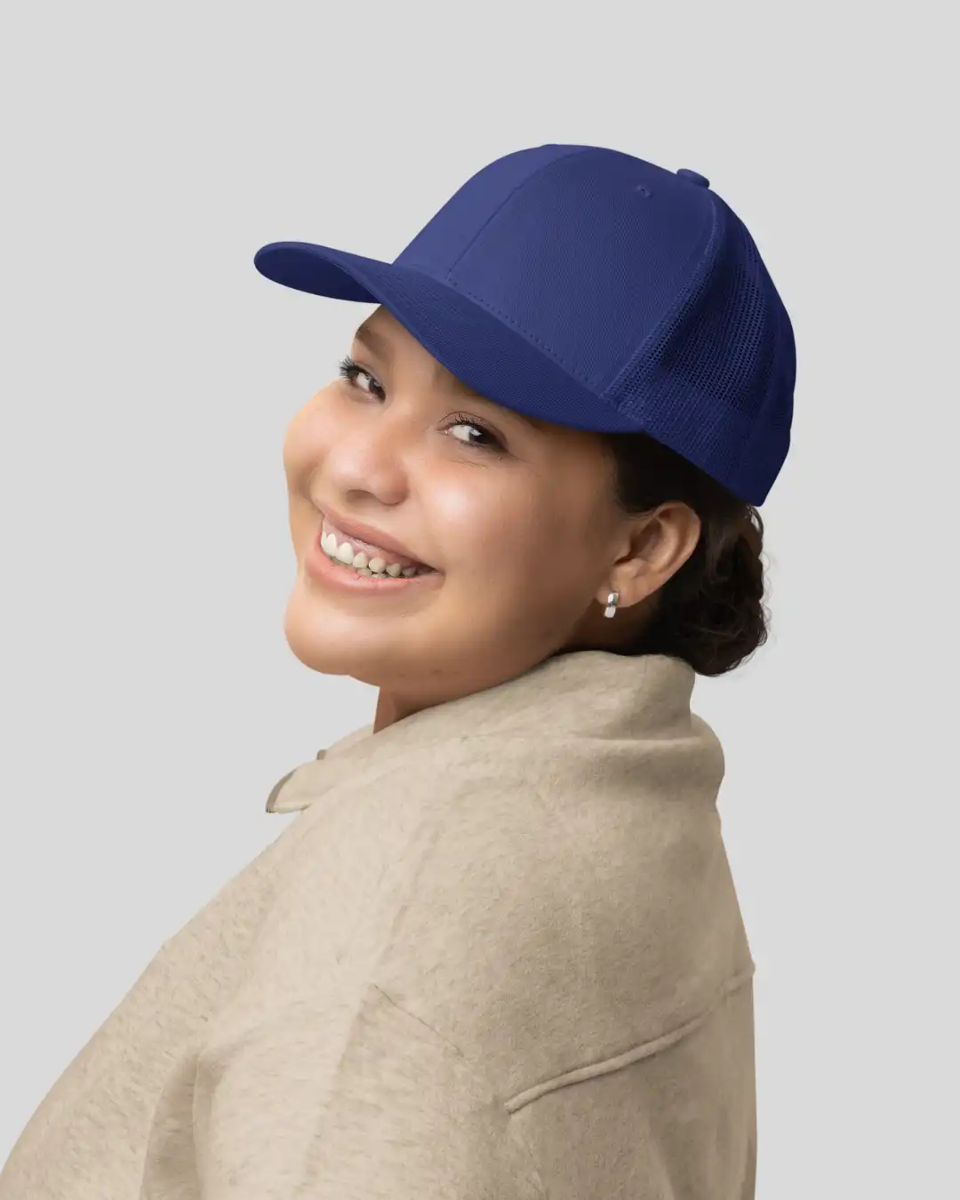 Woman wearing M4S Solids Royal Blue Unisex Classic Trucker Cap in a studio Woman wearing M4S Solids Royal Blue Unisex Classic Trucker Cap in a studio