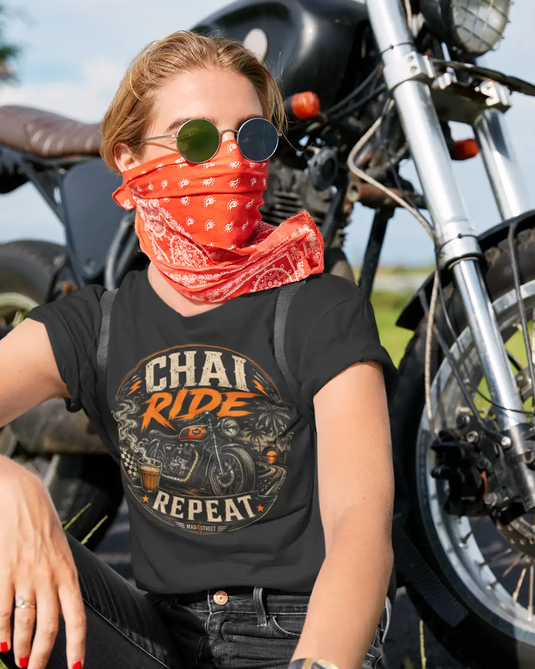 Lifestyle Shot of a Female Biker in Chai Ride Repeat Black Classic Tee Lifestyle Shot of a Female Biker in Chai Ride Repeat Black Classic Tee