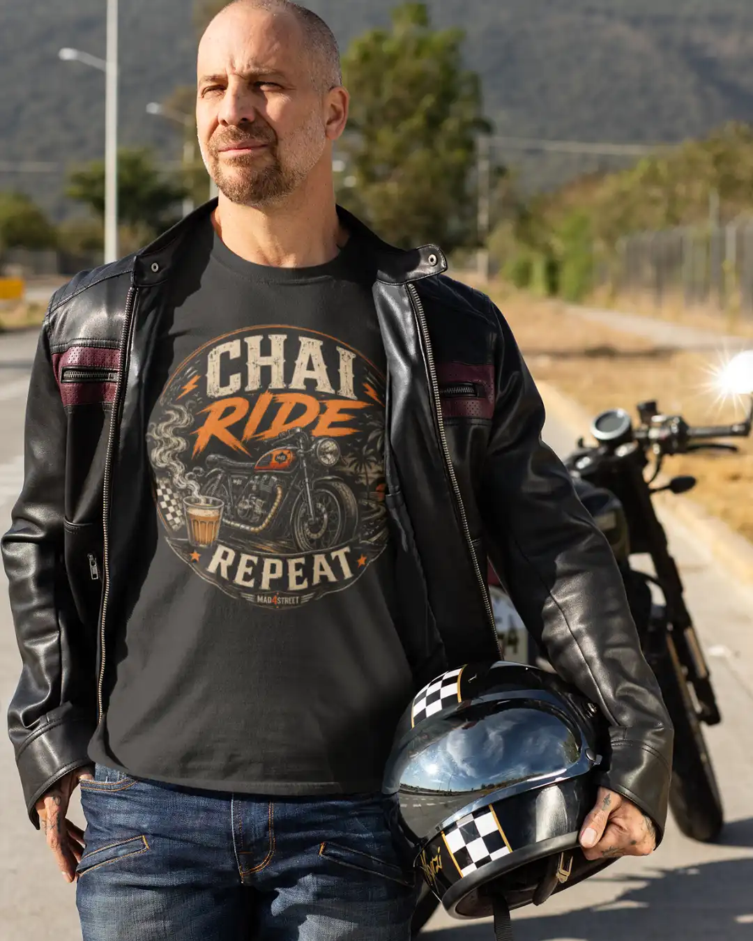 Lifestyle Shot of a Male Biker in Chai Ride Repeat Black Classic Tee Lifestyle Shot of a Male Biker in Chai Ride Repeat Black Classic Tee