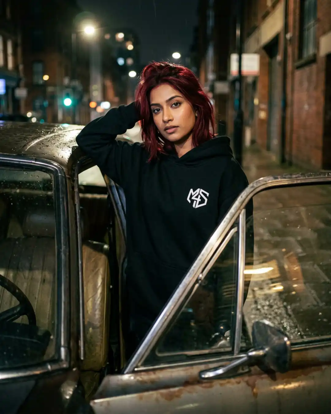 Off Autopilot Hoodie – Ride – Car Woman wearing the Off Autopilot Hoodie beside a classic car at night