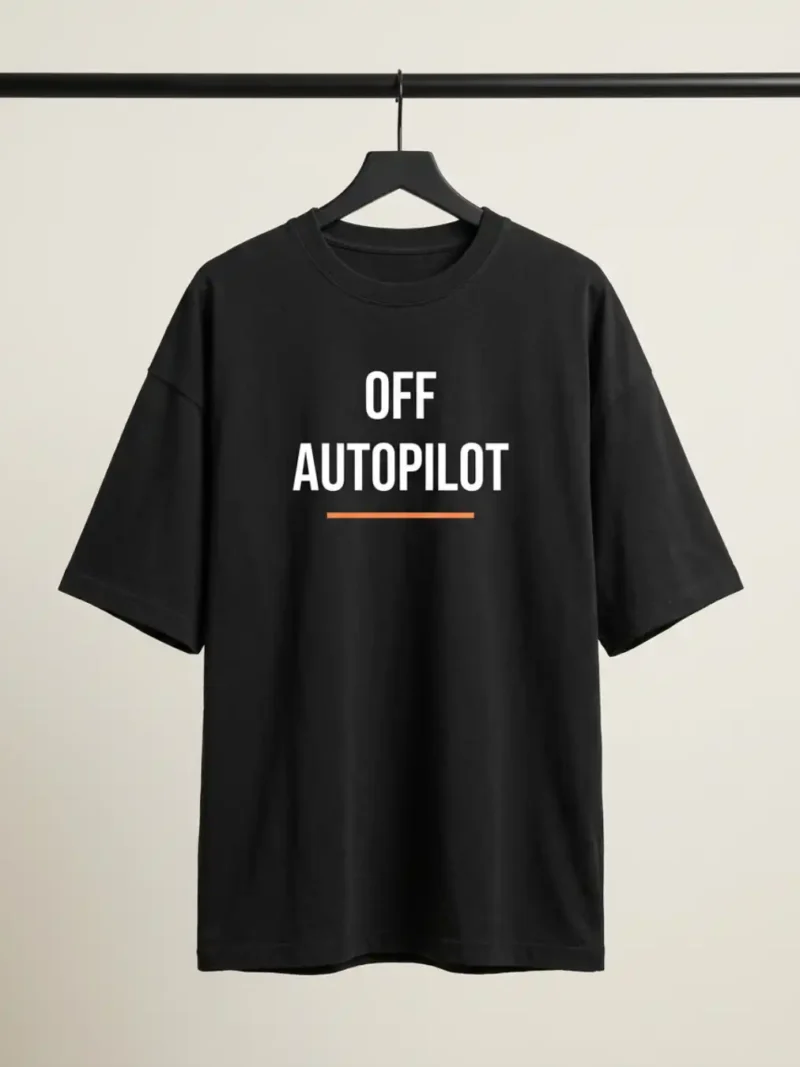 Front view of the black Off Autopilot Oversized Tee showing the Off Autopilot graphic and orange underline