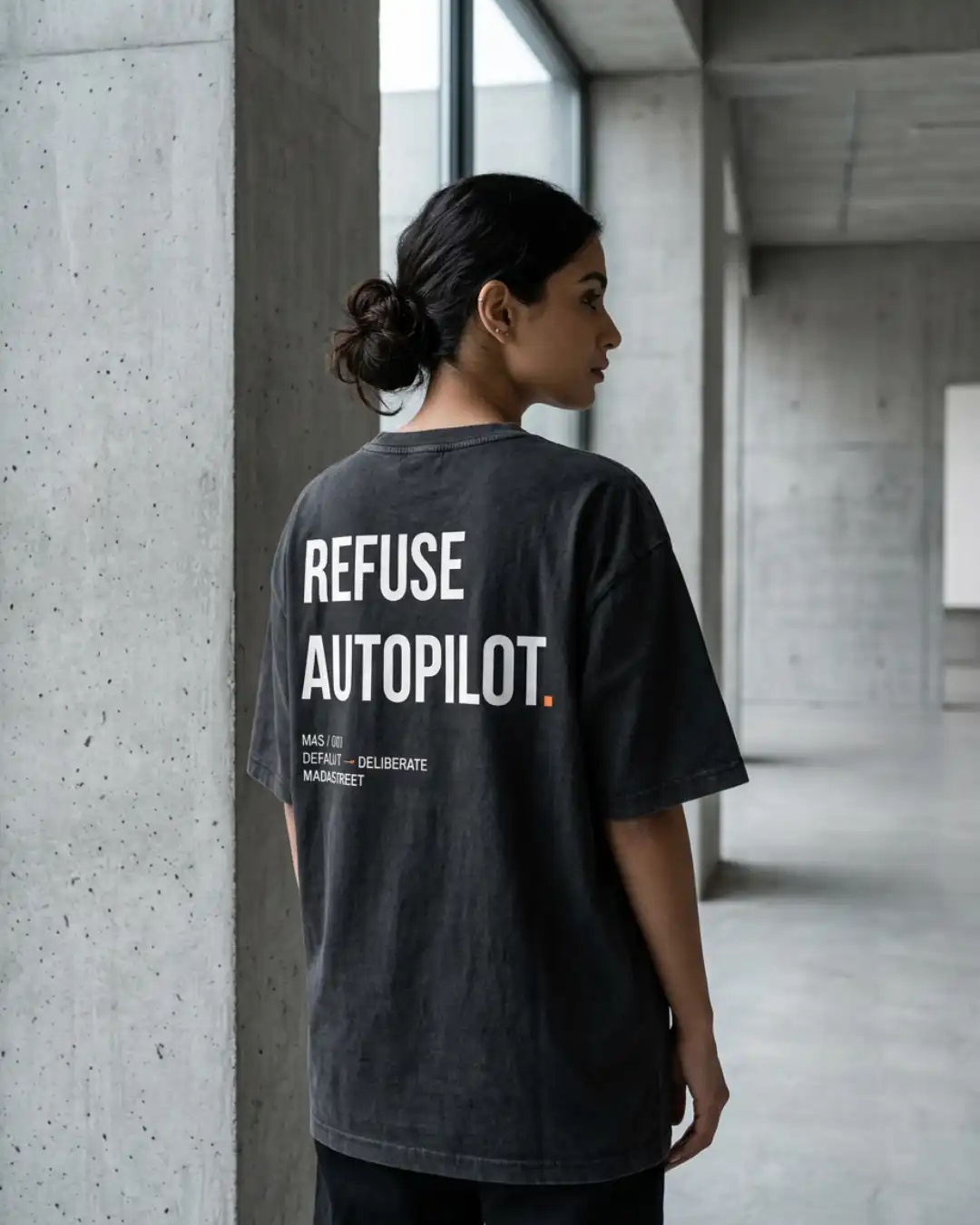 Refuse Autopilot Heavyweight Oversized Tee – Female Model Female model wearing the black Refuse Autopilot Heavyweight Oversized Tee with the M4S Symbol in an urban setting