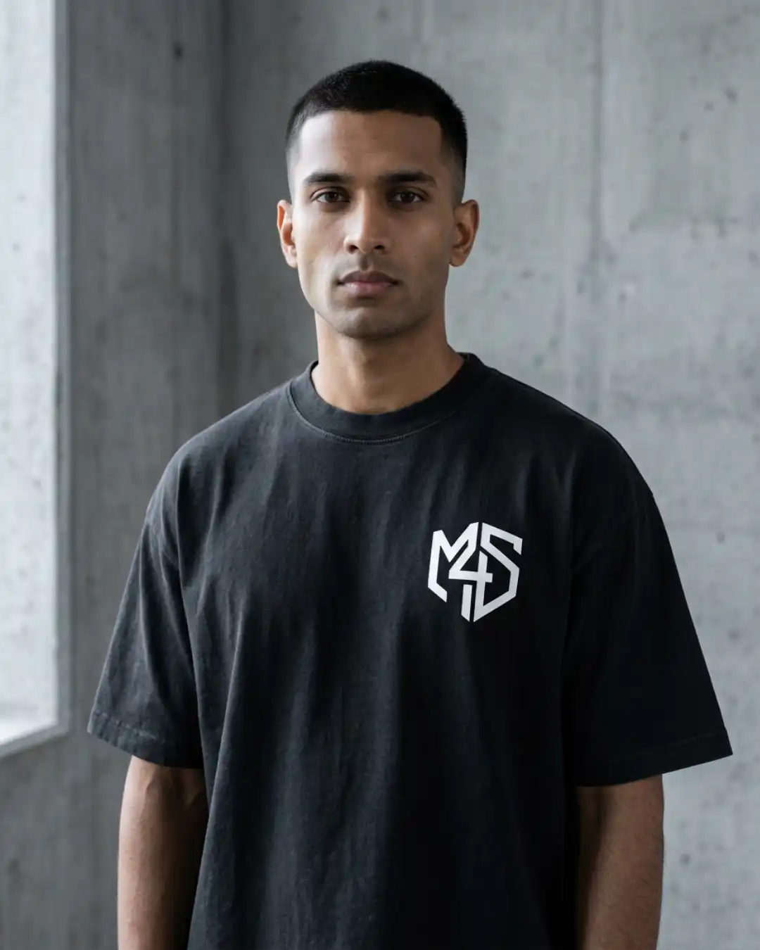 Refuse Autopilot Heavyweight Oversized Tee – Male Model Male model wearing the black Refuse Autopilot Heavyweight Oversized Tee with the M4S Symbol in an urban setting